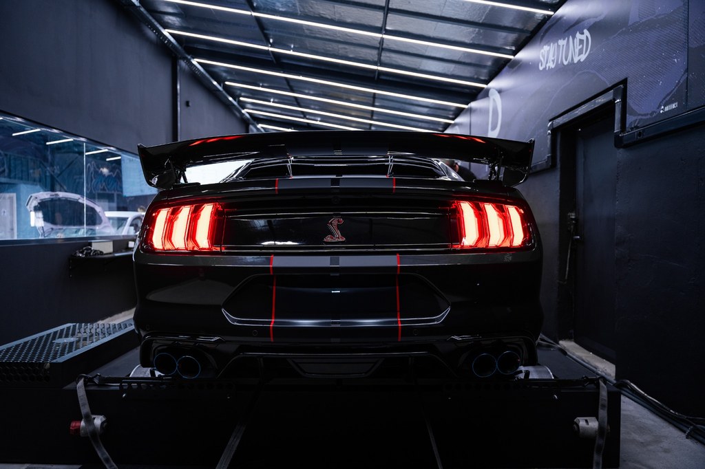 Ford Mustang undergoing performance testing on a dynamometer
